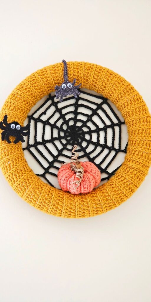 Make a spooky Crochet Halloween Wreath Free Pattern with added appliques like spider web lace, spiders and pumpkins. 